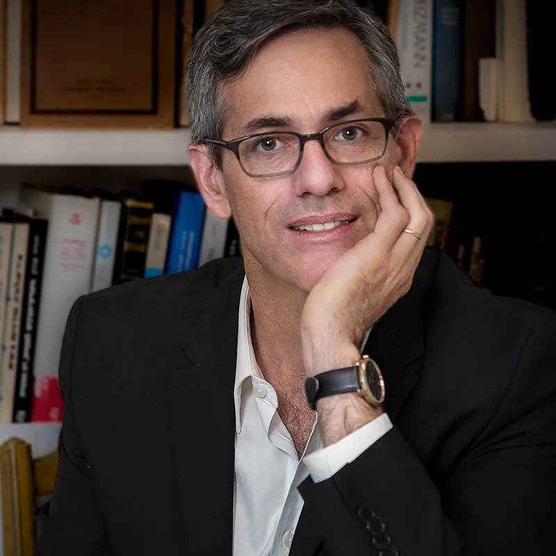 David Myers posing in front of a bookcase.